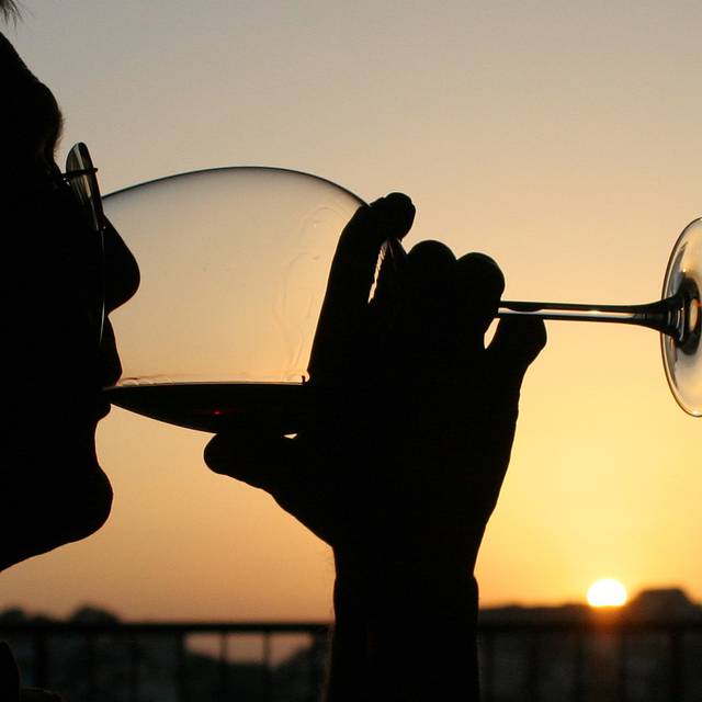 A glass of wine at sunset