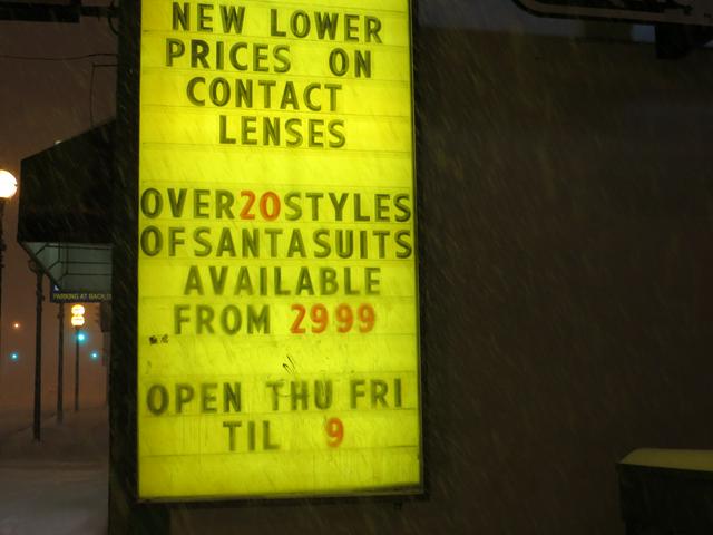 20+ varieties of Santa suits (and prescription eye wear, apparently) on Osborne St at the onset of a blizzard