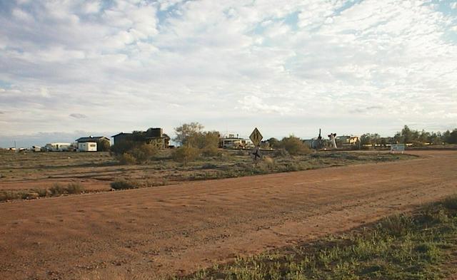 The road into William Creek, with the township in the background. Watch out for airplanes!