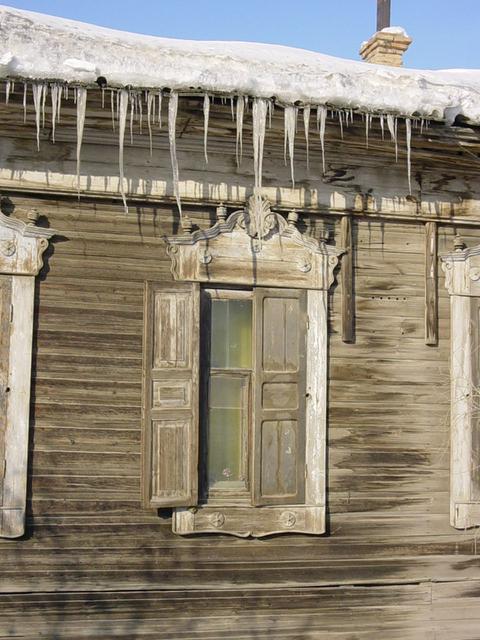 Icicles on traditional Siberian wooden architecture.