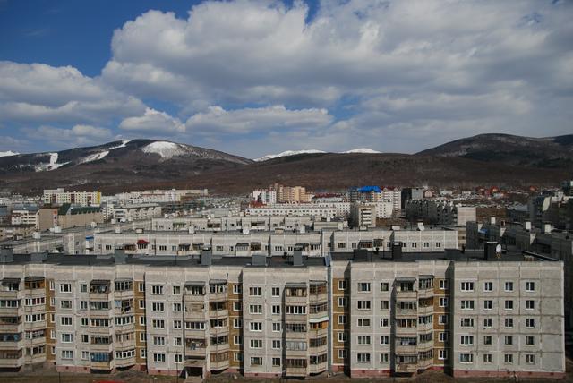 The typical landscape of Yuzhno-Sakhalinsk: Soviet-style buildings and picturesque mountains